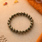 Bracelet on a stone surface with incense and flowers, evoking a sense of tranquility.